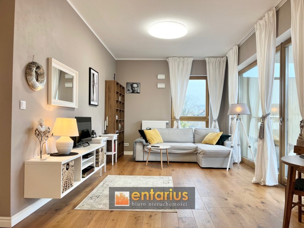 Jasny salon z szarą sofą